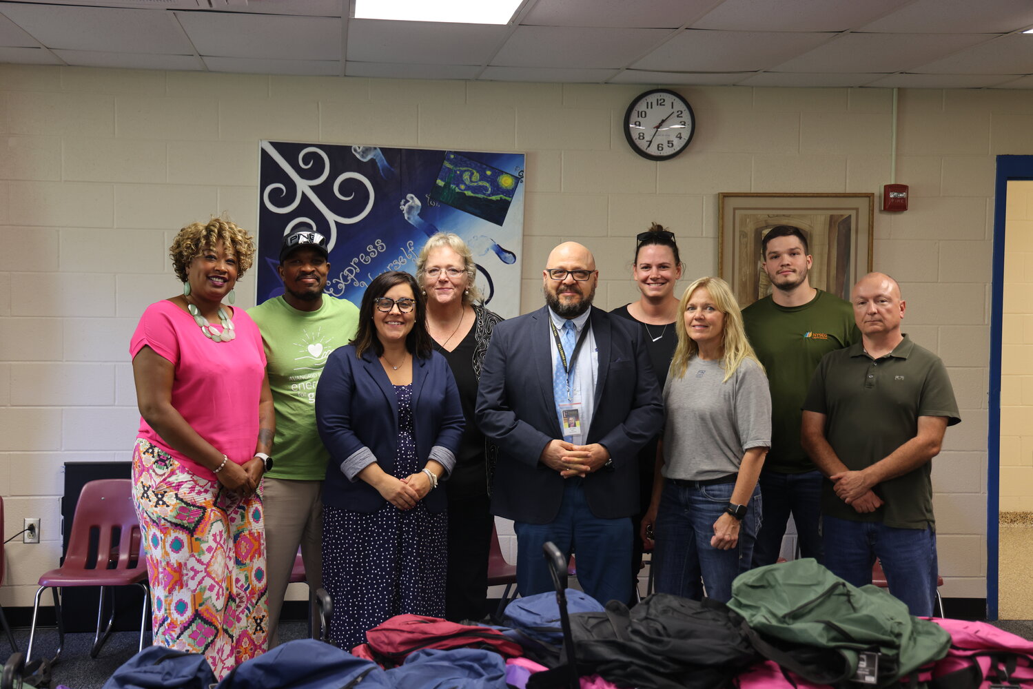 Providing backpacks for kids in Fallsburg. Pictured are ATI’s Children and Family Services Program Manager Akilah Sutphin, left; NYSEG’s Program Manager, Uthman Aziz; Fallsburg’s Director of Pupil Personnel Services Leighanne Russell; Assistant Superintendent for Curriculum and Instruction Sally Sharkey; Superintendent Dr. Ivan Katz; NYSEG’s Gabi Matthews; Dena Schulte; Travis Kelly; and NYSEG Regional Manager John Schneck.